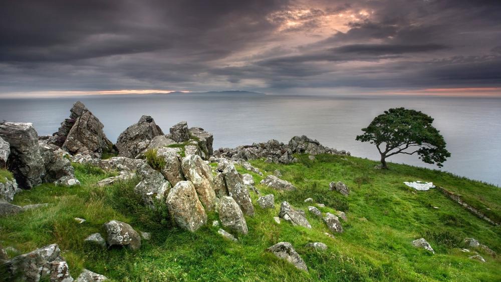 Serene Coastal Landscape with Dramatic Skies wallpaper