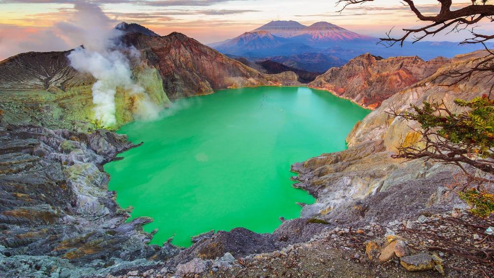Emerald Crater Surrounded by Majestic Mountains wallpaper