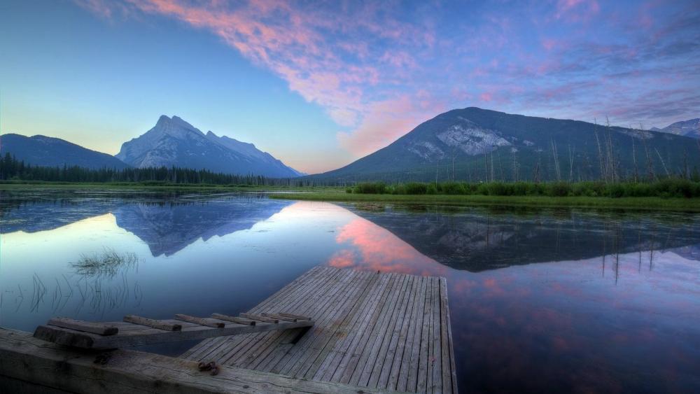 Tranquil Lake at Dawn With Majestic Mountains wallpaper