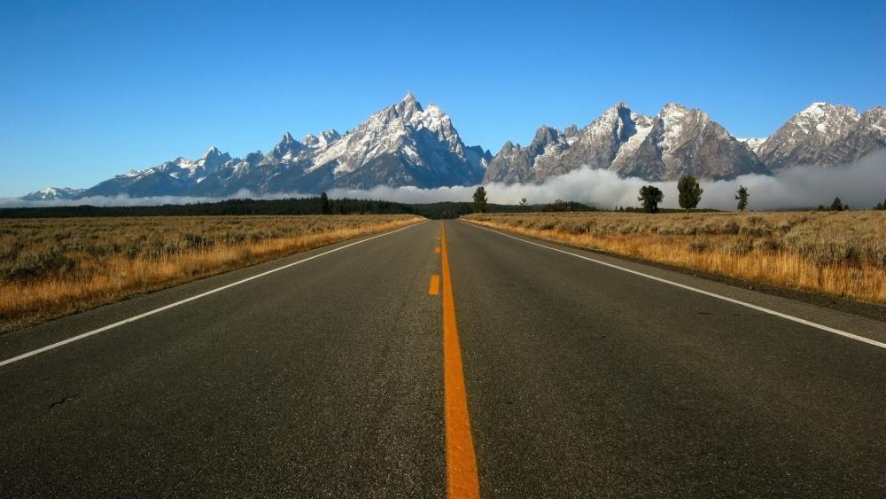 Majestic Roadway to Serene Mountains wallpaper