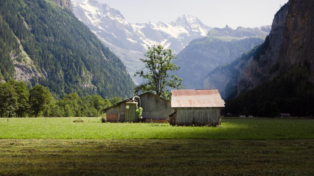 Tranquil Mountain Landscape with Rustic Barns wallpaper