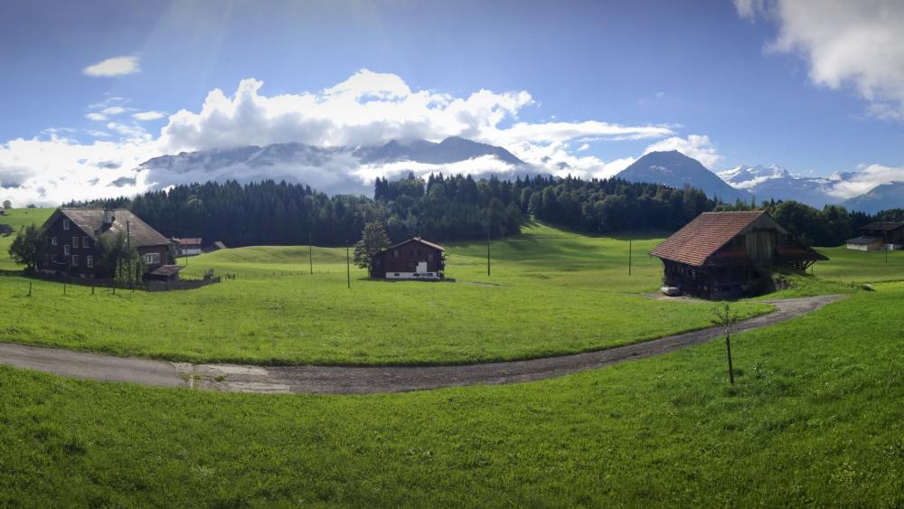 Serene Swiss Countryside Landscape Offering Peaceful Retreat wallpaper
