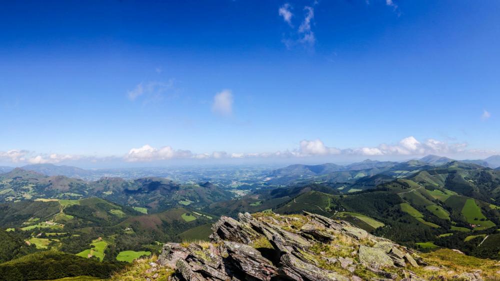 Breathtaking Mountain View Amidst Tranquil Skies wallpaper