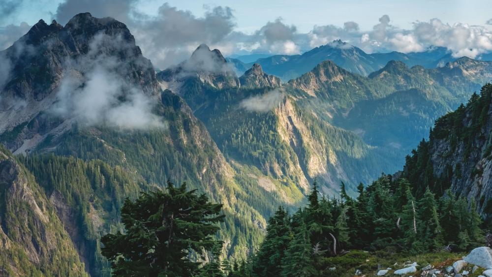 Majestic Mountain Landscape with Lush Greenery and Clouds wallpaper