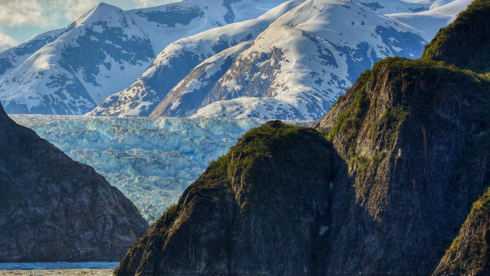 Majestic Glacial Landscape Amidst Rugged Mountains wallpaper
