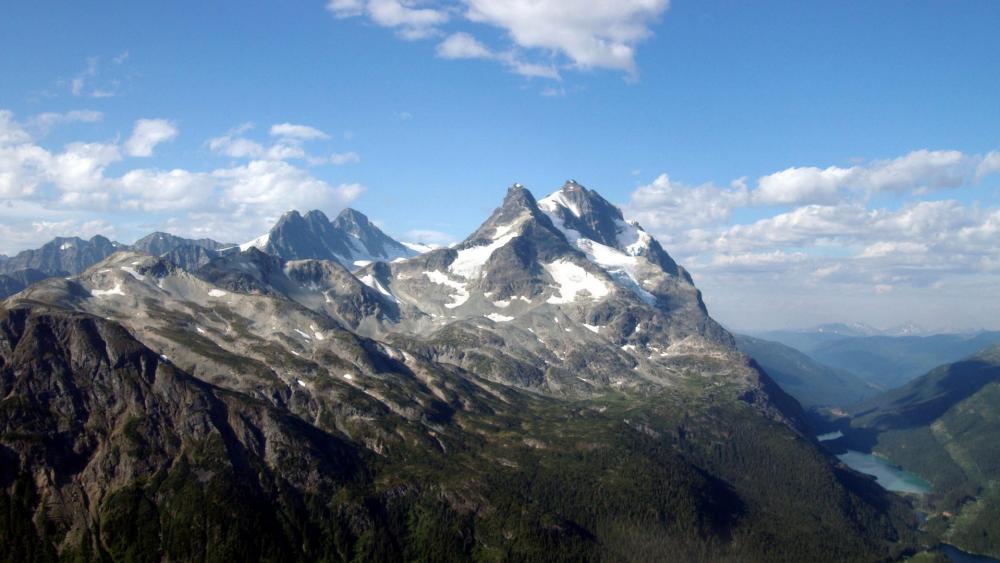 Majestic Peaks Against a Clear Blue Sky wallpaper