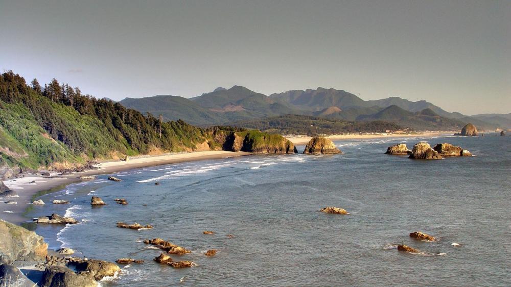 Serene Coastal Landscape with Mountain Backdrop wallpaper