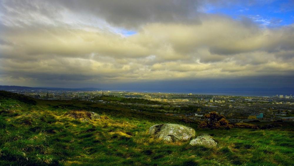 Breathtaking Overlook of Rolling Hills and Cityscape wallpaper