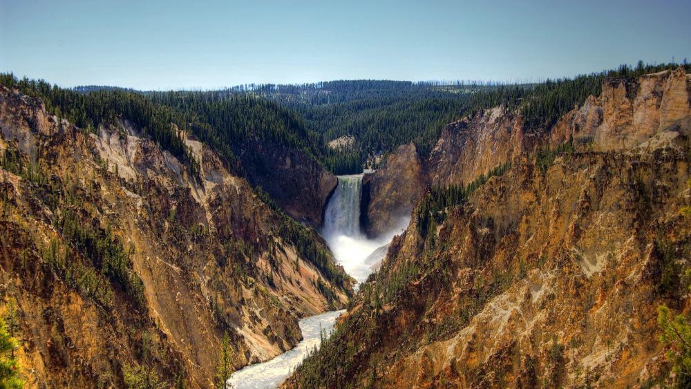 Majestic Falls Amidst Rugged Landscapes wallpaper