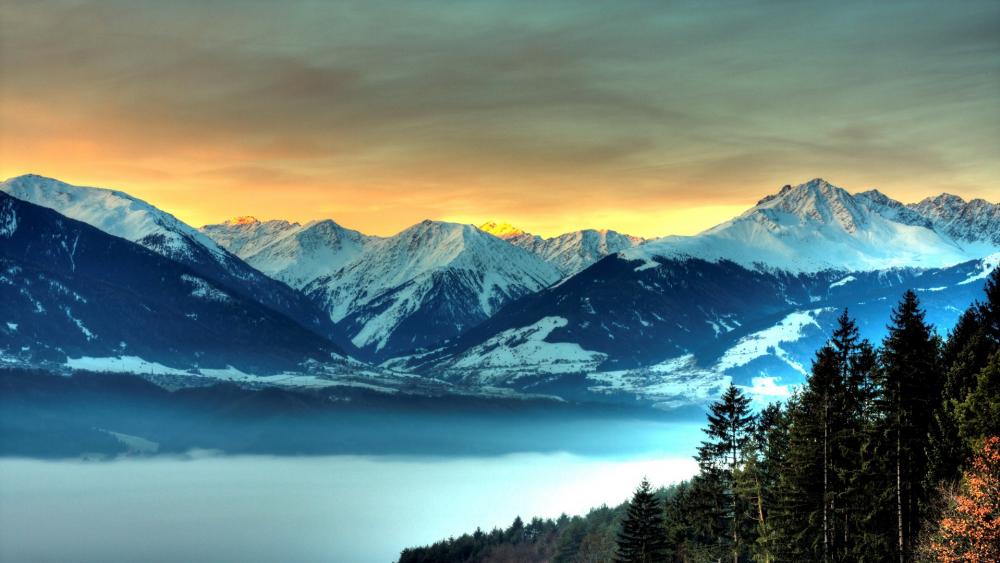 Majestic Mountains at Dusk Overlooking a Misty Valley wallpaper