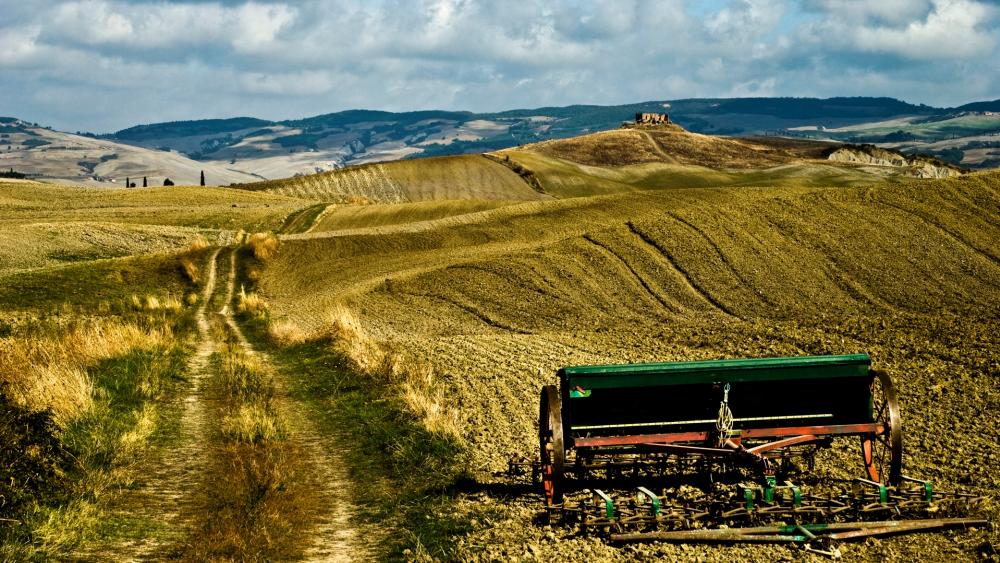 Scenic Vintage Landscape with Rolling Hills and Plowed Fields wallpaper