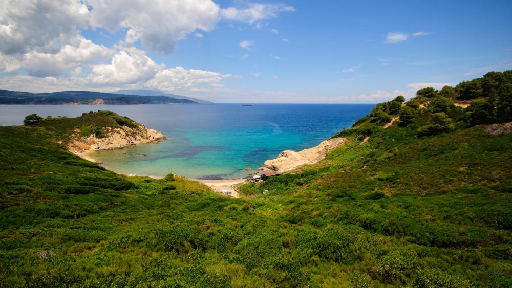Serene Coastal Landscape under a Blue Sky wallpaper