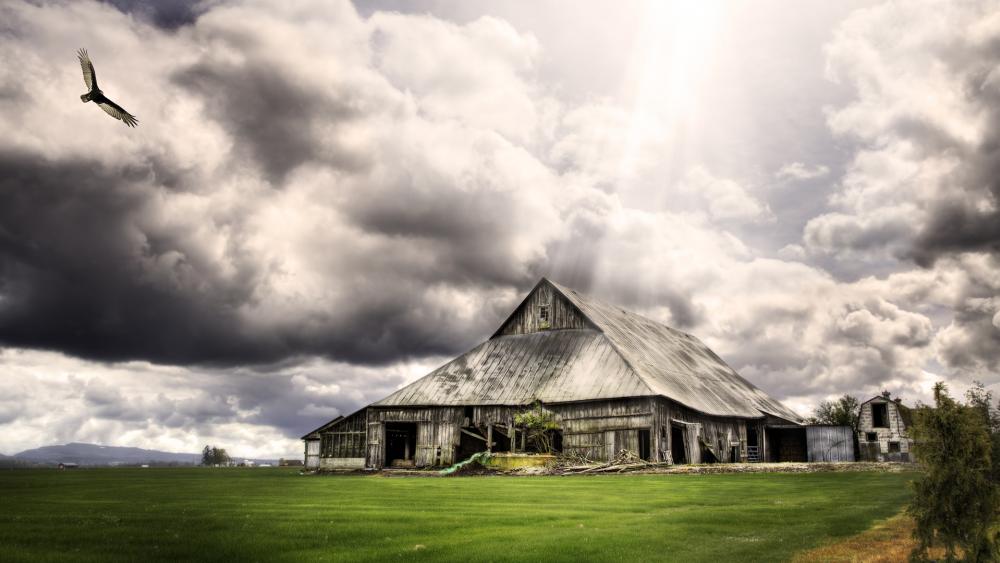 Majestic Barn Under Dark Clouds wallpaper