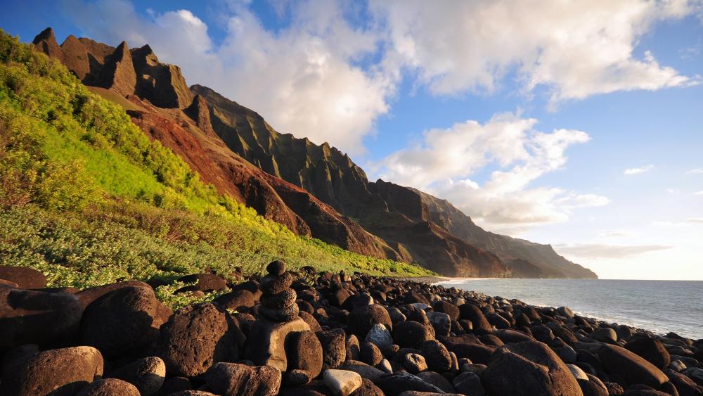 Serene Coastal Landscape with Majestic Mountains and Rocks wallpaper