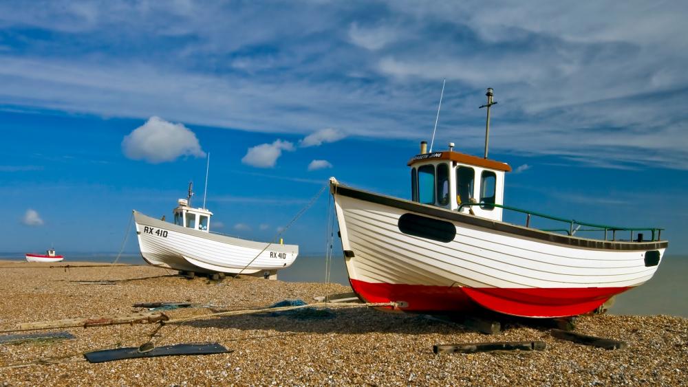 Boats Resting on a Pebble Beach wallpaper