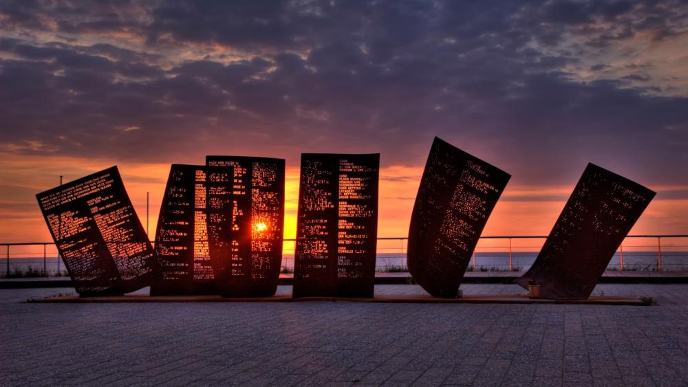 Breathtaking Sunset Behind Sculptural Art Installation wallpaper