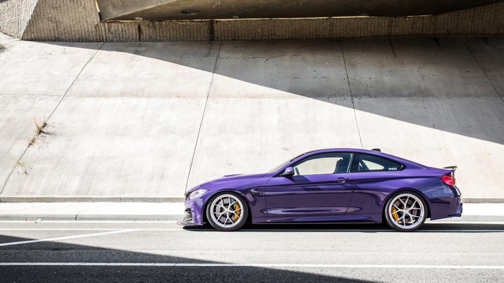 Sleek Purple Sports Car Under Urban Overpass wallpaper