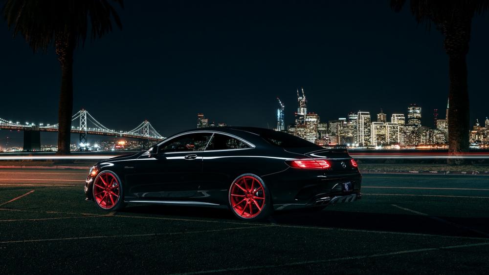 Sleek Night Drive with Cityscape Backdrop wallpaper