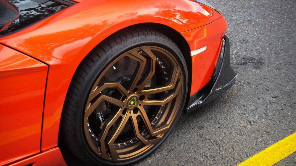 Sleek Orange Car with Stunning Wheels wallpaper