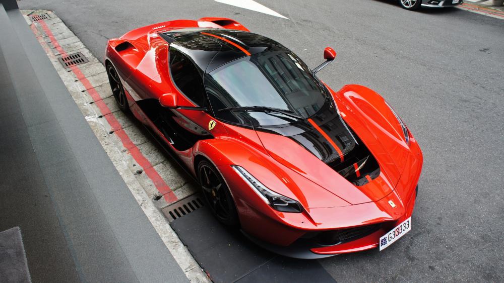 Sleek Red Supercar on Urban Streets wallpaper