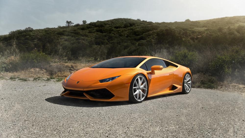 Vibrant Orange Lamborghini on a Scenic Roadway wallpaper
