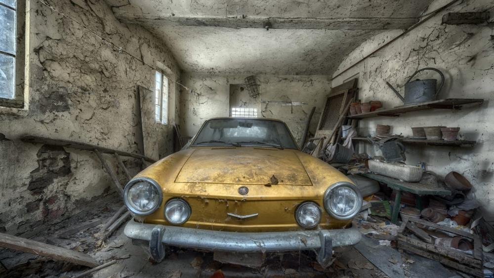 Abandoned Vintage Car in Dusty Garage wallpaper