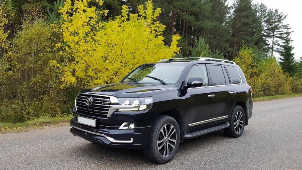 Sleek Black SUV on Autumn Road wallpaper