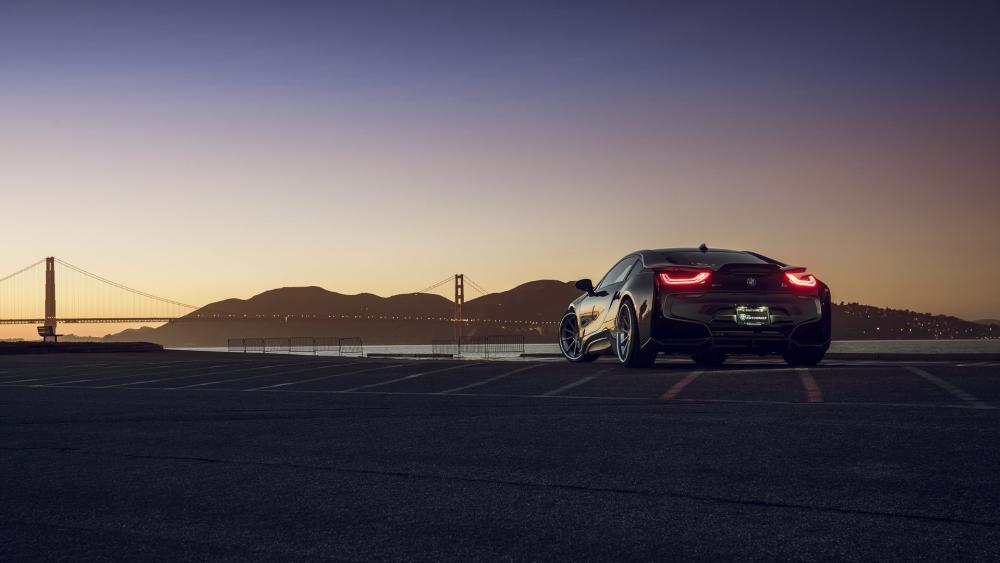 Sleek Car Against a Stunning Sunset Backdrop wallpaper