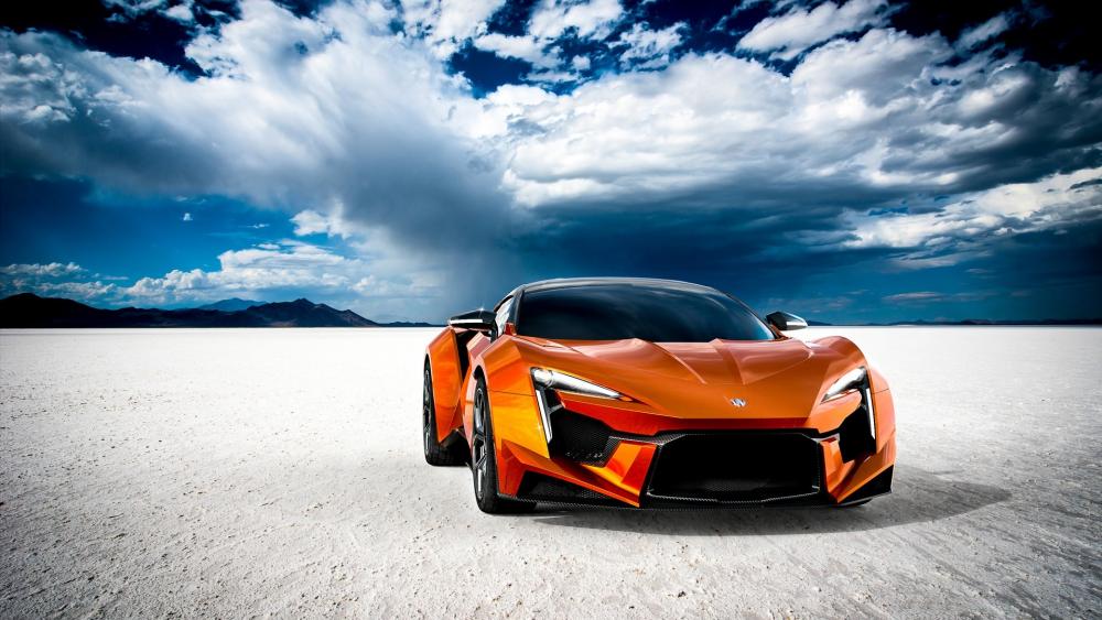 Dynamic Orange Supercar in a Desert Landscape wallpaper
