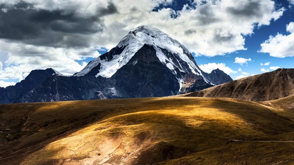 Majestic Mountain Peak Under a Vast Sky wallpaper