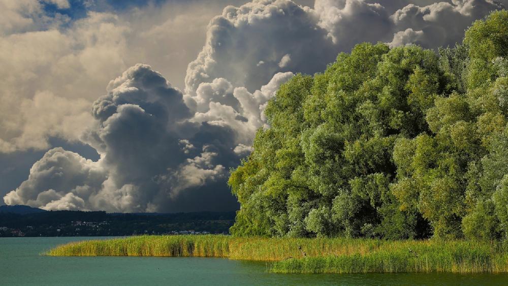 Majestic Clouds Over Serene Lake Scene wallpaper