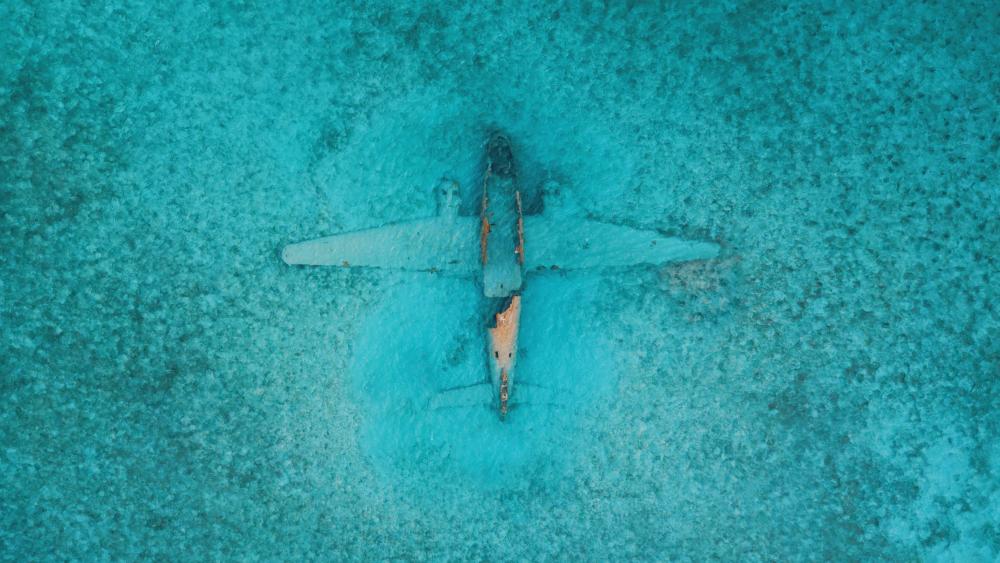 Airplane under the sea from above wallpaper