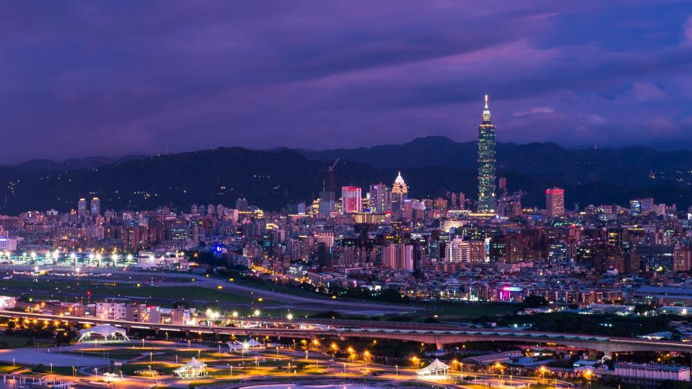 Vibrant Nightscape of a Bustling City Skyline wallpaper