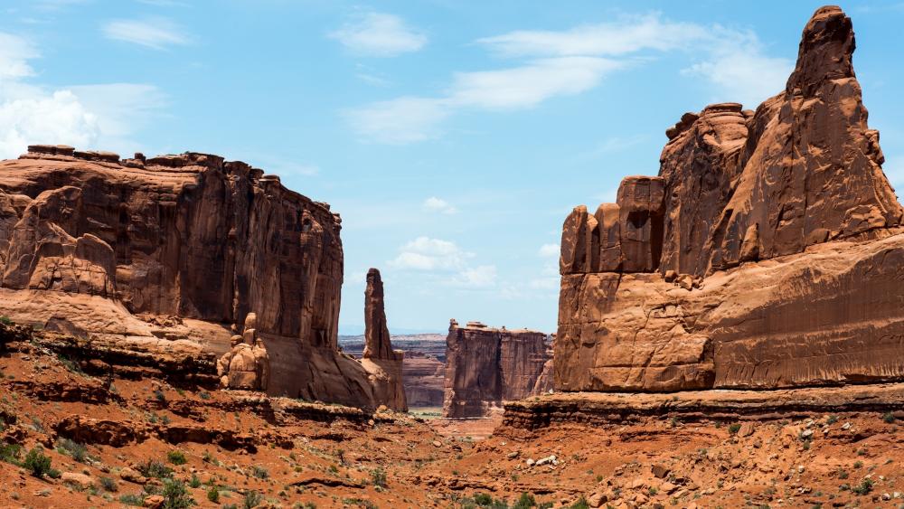 Majestic Desert Landscape with Towering Rock Formations wallpaper