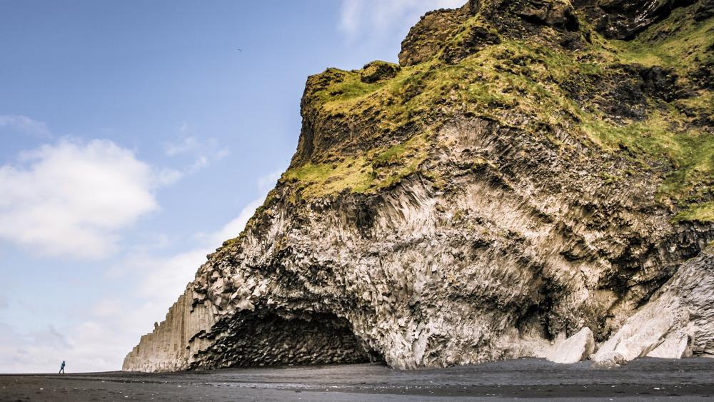 Majestic Coastal Rock Formation Against a Blue Sky wallpaper
