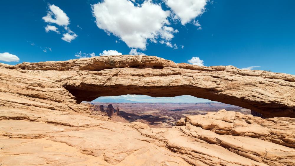 Majestic Natural Arch Under a Vibrant Sky wallpaper