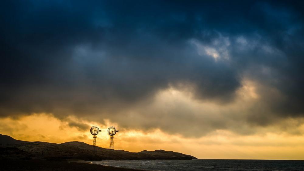 Majestic Windmills Against Stormy Sky wallpaper