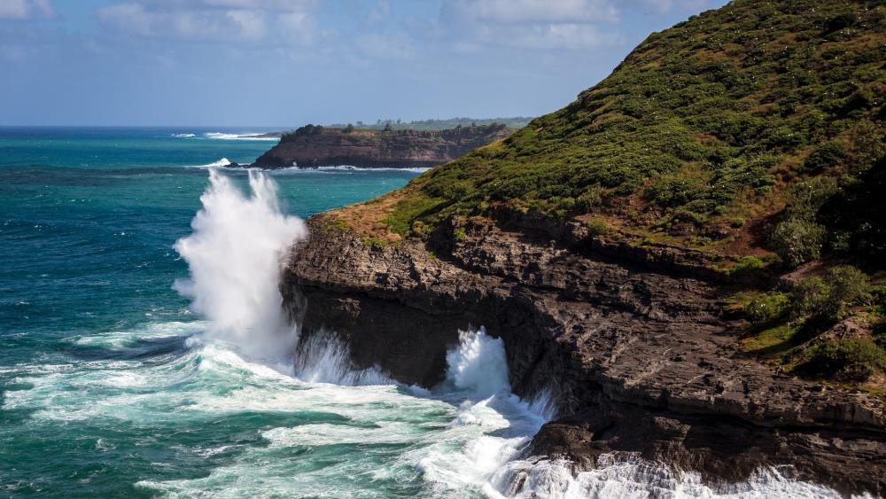 Majestic Coastal Waves Crashing Against Rocky Cliffs wallpaper
