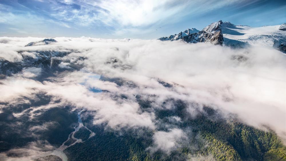 Majestic Mountain Peaks Shrouded in Clouds wallpaper