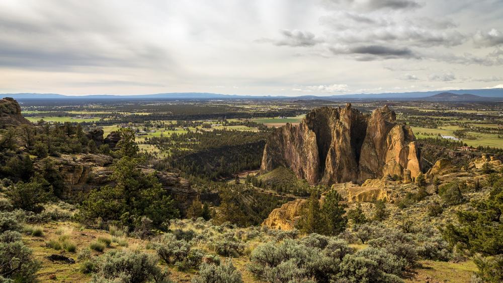 Majestic Rock Formations Amidst Lush Landscape wallpaper