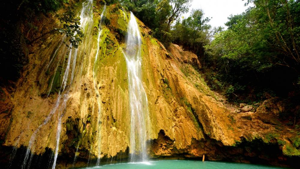 Serene Waterfalls Amidst Lush Greenery wallpaper