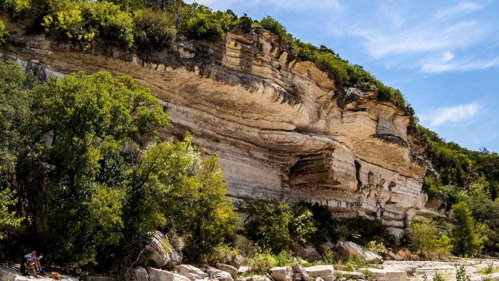 Majestic Rock Formations Surrounded by Lush Greenery wallpaper