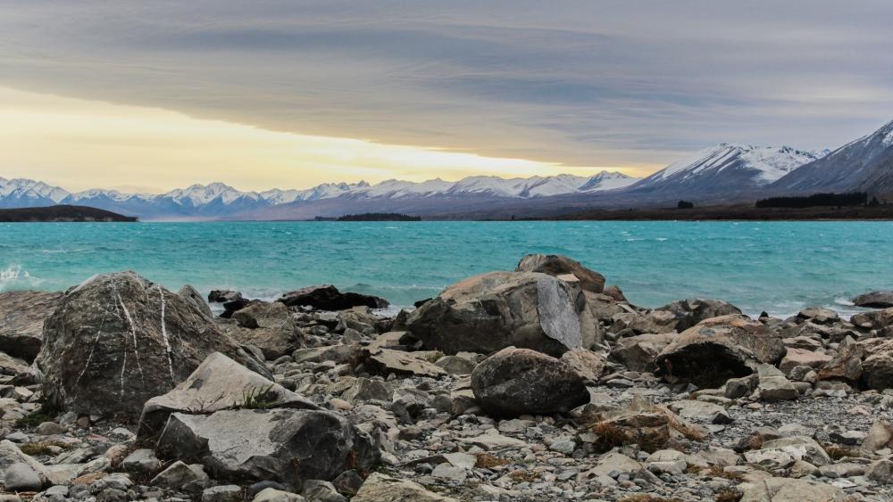 Tranquil Waters Amidst Majestic Mountains wallpaper