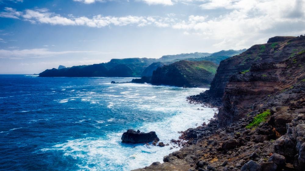 Serene Coastal Landscape Under a Bright Sky wallpaper