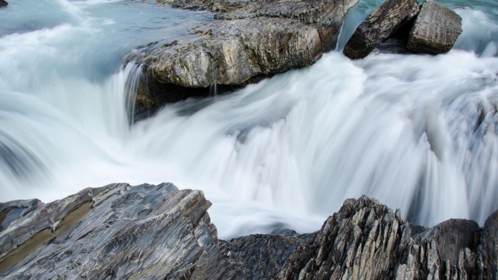Serene River Cascade in Nature's Embrace wallpaper