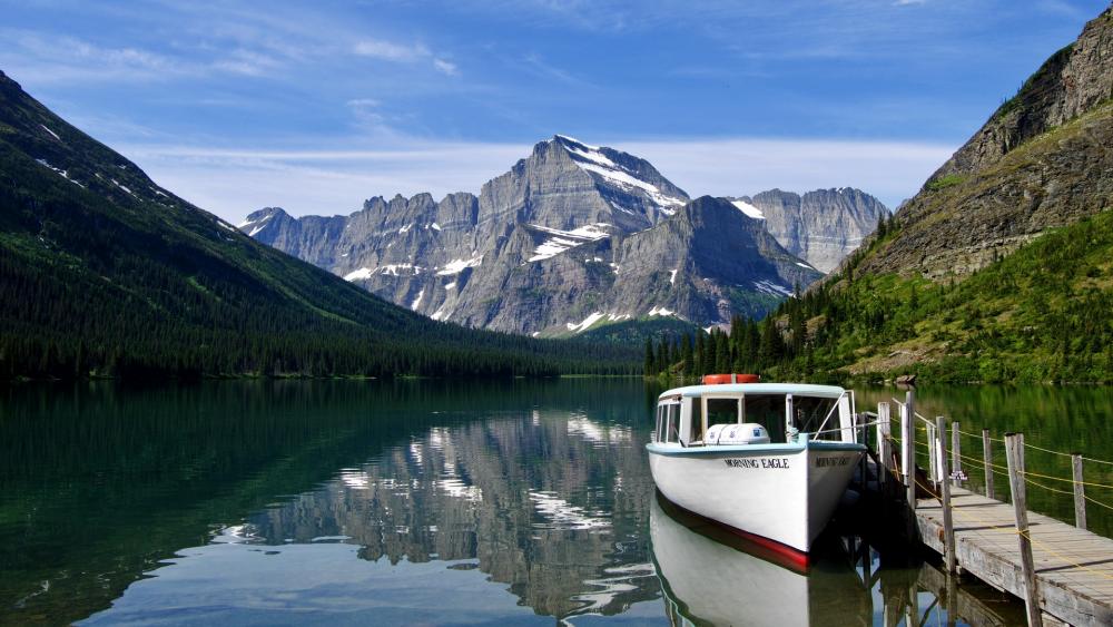 Serene Mountain Lake with Boat Reflection wallpaper