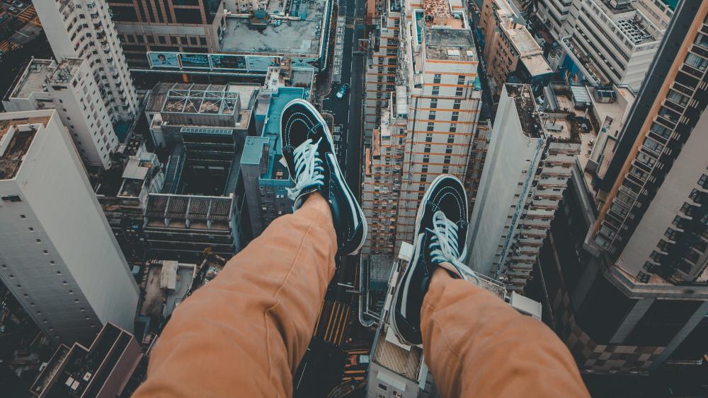 Dangling Feet Above The Metropolis wallpaper