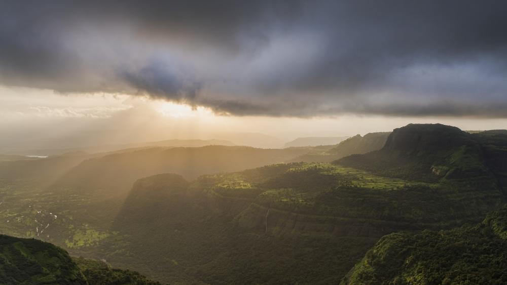 Majestic Mountain View Amidst Shimmering Light wallpaper