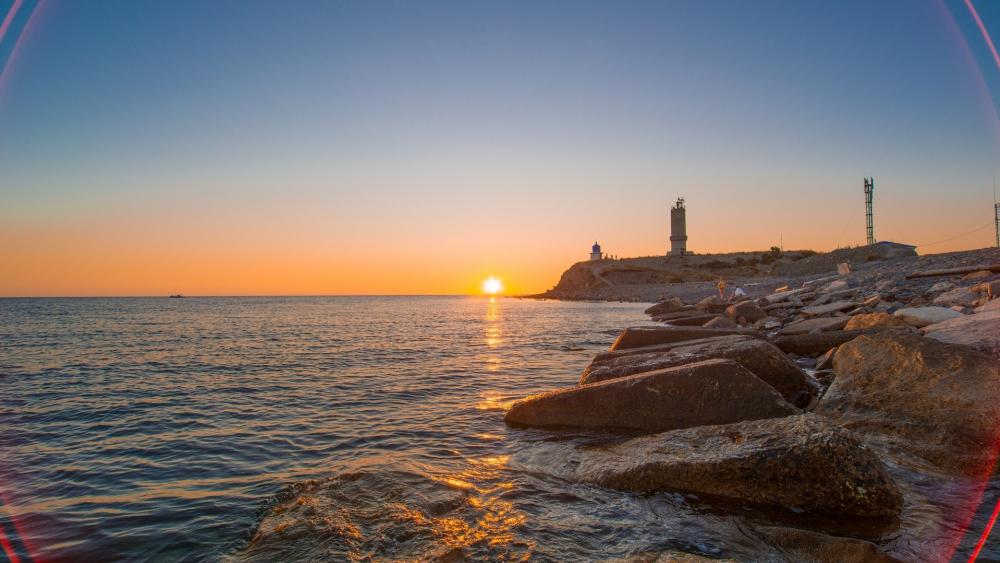 Tranquil Sunset by the Lighthouse wallpaper