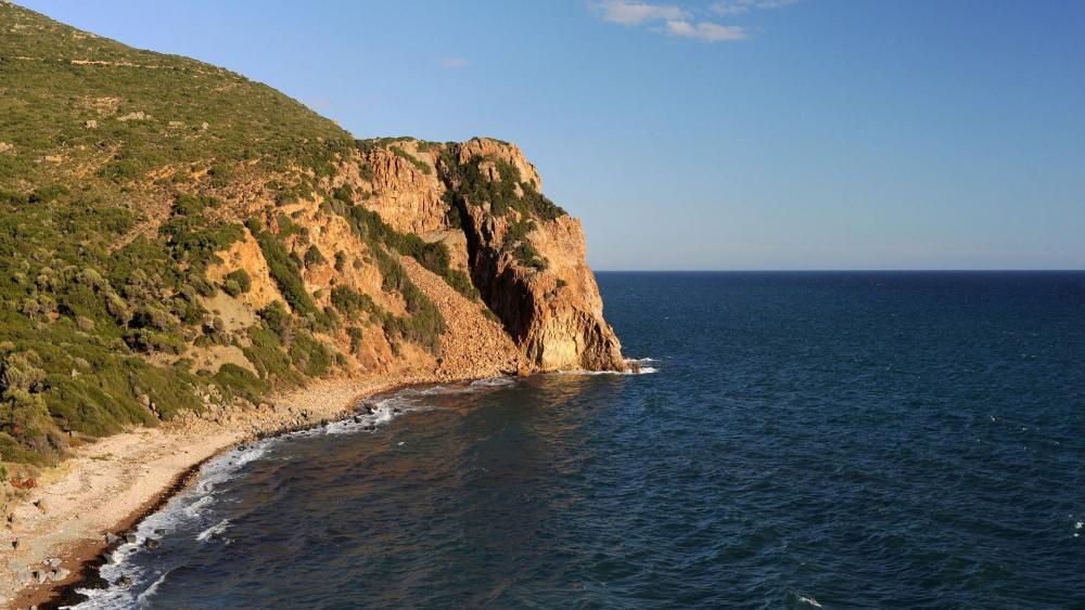 Coastal Serenity with Rocky Cliffs and Calm Waters wallpaper